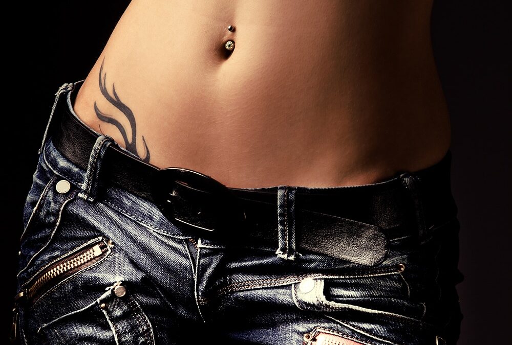 woman wearing jeans with hip tattoo