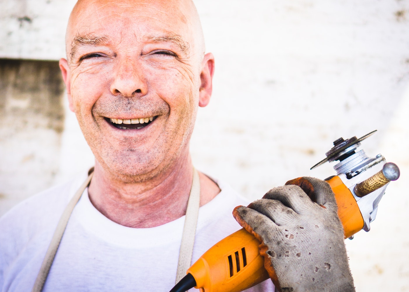 man holding tool smiling